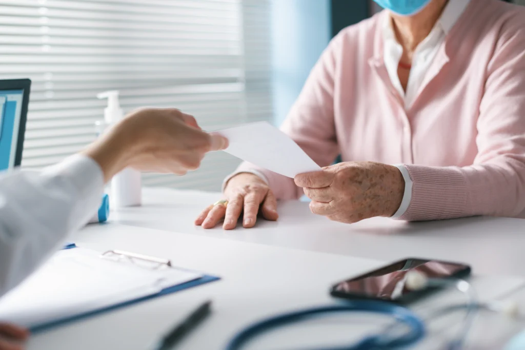 doctor giving a prescription to a elderly woman 2023 11 27 05 27 54 utc